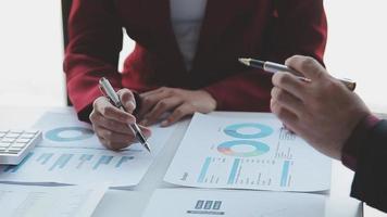 Financial analysts analyze business financial reports on a digital tablet planning investment project during a discussion at a meeting of corporate showing the results of their successful teamwork. video