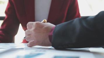 Financial analysts analyze business financial reports on a digital tablet planning investment project during a discussion at a meeting of corporate showing the results of their successful teamwork. video