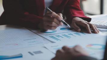 Financial analysts analyze business financial reports on a digital tablet planning investment project during a discussion at a meeting of corporate showing the results of their successful teamwork. video