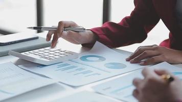 Financial analysts analyze business financial reports on a digital tablet planning investment project during a discussion at a meeting of corporate showing the results of their successful teamwork. video