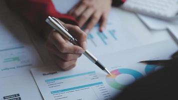 Financial analysts analyze business financial reports on a digital tablet planning investment project during a discussion at a meeting of corporate showing the results of their successful teamwork. video