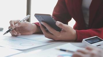 Financial analysts analyze business financial reports on a digital tablet planning investment project during a discussion at a meeting of corporate showing the results of their successful teamwork. video
