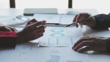 Financial analysts analyze business financial reports on a digital tablet planning investment project during a discussion at a meeting of corporate showing the results of their successful teamwork. video