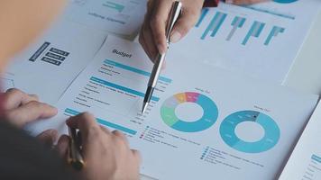 Financial analysts analyze business financial reports on a digital tablet planning investment project during a discussion at a meeting of corporate showing the results of their successful teamwork. video