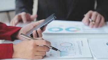 Financial analysts analyze business financial reports on a digital tablet planning investment project during a discussion at a meeting of corporate showing the results of their successful teamwork. video