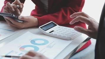 Financial analysts analyze business financial reports on a digital tablet planning investment project during a discussion at a meeting of corporate showing the results of their successful teamwork. video