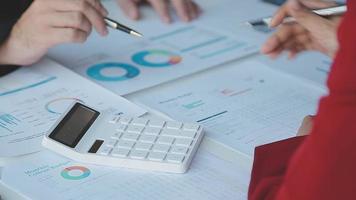 Financial analysts analyze business financial reports on a digital tablet planning investment project during a discussion at a meeting of corporate showing the results of their successful teamwork. video