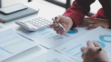 Financial analysts analyze business financial reports on a digital tablet planning investment project during a discussion at a meeting of corporate showing the results of their successful teamwork. video