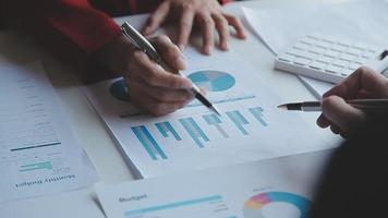 Financial analysts analyze business financial reports on a digital tablet planning investment project during a discussion at a meeting of corporate showing the results of their successful teamwork. video