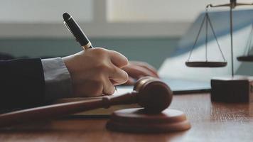 Male lawyer working with contract papers and wooden gavel on tabel in courtroom. justice and law ,attorney, court judge, concept. video