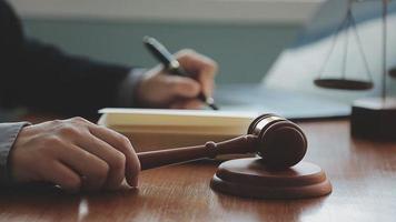 Male lawyer working with contract papers and wooden gavel on tabel in courtroom. justice and law ,attorney, court judge, concept. video