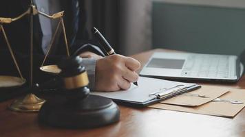 Male lawyer working with contract papers and wooden gavel on tabel in courtroom. justice and law ,attorney, court judge, concept. video