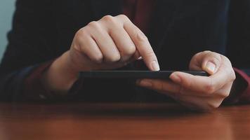 Business partnership coworkers using a tablet to chart company financial statements report and profits work progress and planning in office room. video