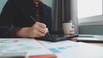 Teamwork of asian business people discussing and calculating with calculator on evaluation data in conference room. with the growth and pointing to the chart graph financial account. video