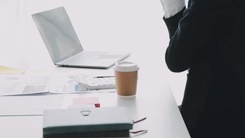 Financial analysts analyze business financial reports on a digital tablet planning investment project during a discussion at a meeting of corporate showing the results of their successful teamwork. video