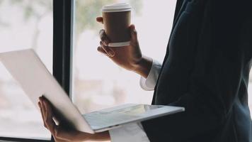 Financial analysts analyze business financial reports on a digital tablet planning investment project during a discussion at a meeting of corporate showing the results of their successful teamwork. video