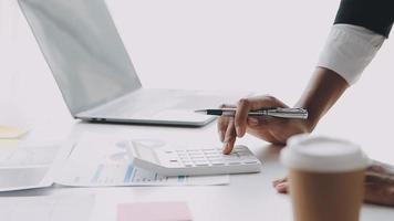 Financial analysts analyze business financial reports on a digital tablet planning investment project during a discussion at a meeting of corporate showing the results of their successful teamwork. video