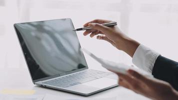 Financial analysts analyze business financial reports on a digital tablet planning investment project during a discussion at a meeting of corporate showing the results of their successful teamwork. video