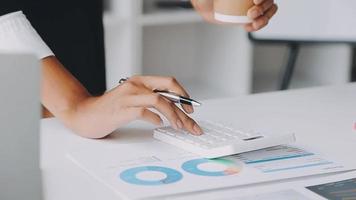 Financial analysts analyze business financial reports on a digital tablet planning investment project during a discussion at a meeting of corporate showing the results of their successful teamwork. video