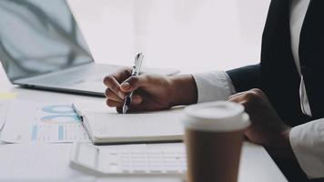 Financial analysts analyze business financial reports on a digital tablet planning investment project during a discussion at a meeting of corporate showing the results of their successful teamwork. video