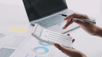 Financial analysts analyze business financial reports on a digital tablet planning investment project during a discussion at a meeting of corporate showing the results of their successful teamwork. video