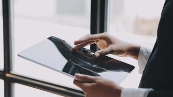 Financial analysts analyze business financial reports on a digital tablet planning investment project during a discussion at a meeting of corporate showing the results of their successful teamwork. video