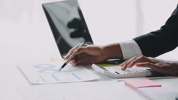 Financial analysts analyze business financial reports on a digital tablet planning investment project during a discussion at a meeting of corporate showing the results of their successful teamwork. video