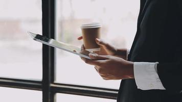 Financial analysts analyze business financial reports on a digital tablet planning investment project during a discussion at a meeting of corporate showing the results of their successful teamwork. video