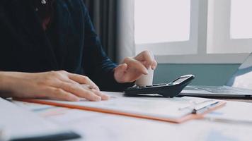 Financial analysts analyze business financial reports on a digital tablet planning investment project during a discussion at a meeting of corporate showing the results of their successful teamwork. video
