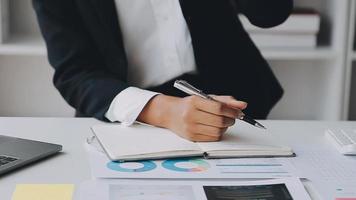 Financial analysts analyze business financial reports on a digital tablet planning investment project during a discussion at a meeting of corporate showing the results of their successful teamwork. video