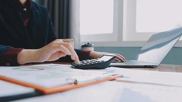 Financial analysts analyze business financial reports on a digital tablet planning investment project during a discussion at a meeting of corporate showing the results of their successful teamwork. video