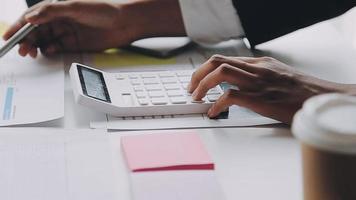 Financial analysts analyze business financial reports on a digital tablet planning investment project during a discussion at a meeting of corporate showing the results of their successful teamwork. video