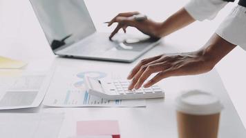 Financial analysts analyze business financial reports on a digital tablet planning investment project during a discussion at a meeting of corporate showing the results of their successful teamwork. video