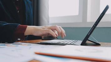 Financial analysts analyze business financial reports on a digital tablet planning investment project during a discussion at a meeting of corporate showing the results of their successful teamwork. video