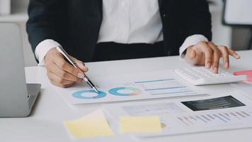 Financial analysts analyze business financial reports on a digital tablet planning investment project during a discussion at a meeting of corporate showing the results of their successful teamwork. video