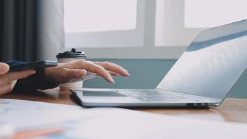 Financial analysts analyze business financial reports on a digital tablet planning investment project during a discussion at a meeting of corporate showing the results of their successful teamwork. video