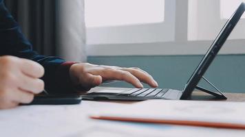 Financial analysts analyze business financial reports on a digital tablet planning investment project during a discussion at a meeting of corporate showing the results of their successful teamwork. video