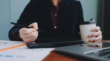 Financial analysts analyze business financial reports on a digital tablet planning investment project during a discussion at a meeting of corporate showing the results of their successful teamwork. video