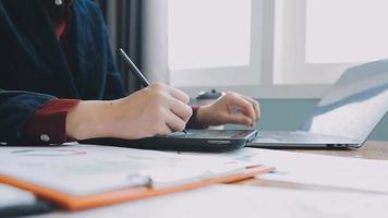 Financial analysts analyze business financial reports on a digital tablet planning investment project during a discussion at a meeting of corporate showing the results of their successful teamwork. video