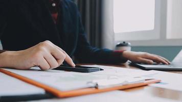 Financial analysts analyze business financial reports on a digital tablet planning investment project during a discussion at a meeting of corporate showing the results of their successful teamwork. video