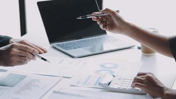 Financial analysts analyze business financial reports on a digital tablet planning investment project during a discussion at a meeting of corporate showing the results of their successful teamwork. video