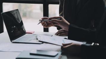 Financial analysts analyze business financial reports on a digital tablet planning investment project during a discussion at a meeting of corporate showing the results of their successful teamwork. video