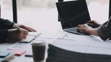 Financial analysts analyze business financial reports on a digital tablet planning investment project during a discussion at a meeting of corporate showing the results of their successful teamwork. video