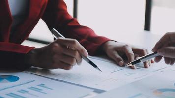 Financial analysts analyze business financial reports on a digital tablet planning investment project during a discussion at a meeting of corporate showing the results of their successful teamwork. video