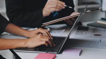 Financial analysts analyze business financial reports on a digital tablet planning investment project during a discussion at a meeting of corporate showing the results of their successful teamwork. video