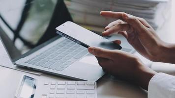 Financial analysts analyze business financial reports on a digital tablet planning investment project during a discussion at a meeting of corporate showing the results of their successful teamwork. video