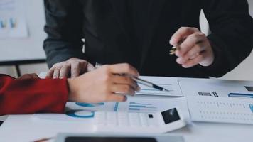 Financial analysts analyze business financial reports on a digital tablet planning investment project during a discussion at a meeting of corporate showing the results of their successful teamwork. video