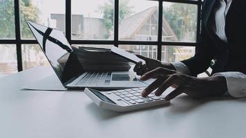 Financial analysts analyze business financial reports on a digital tablet planning investment project during a discussion at a meeting of corporate showing the results of their successful teamwork. video