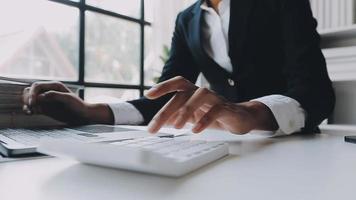 Financial analysts analyze business financial reports on a digital tablet planning investment project during a discussion at a meeting of corporate showing the results of their successful teamwork. video