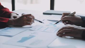 Financial analysts analyze business financial reports on a digital tablet planning investment project during a discussion at a meeting of corporate showing the results of their successful teamwork. video